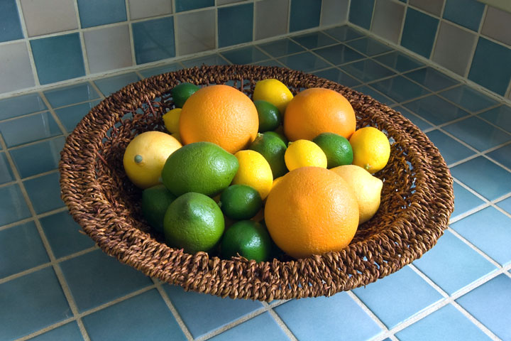basket of fruit on a ceramic tile countertop