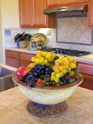 kitchen countertop and backsplash tiles with fruit basket